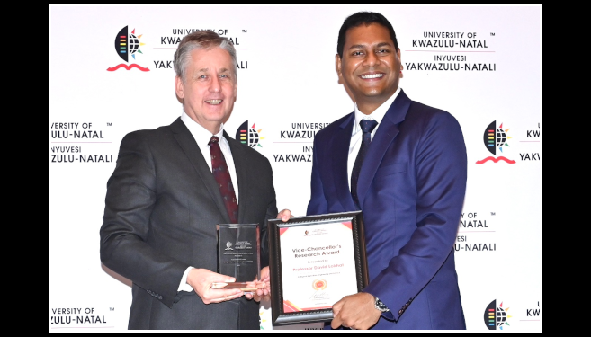 : Professor David Lokhat (right) receiving the Vice-Chancellor’s Research Award from Dr Mark Hay.